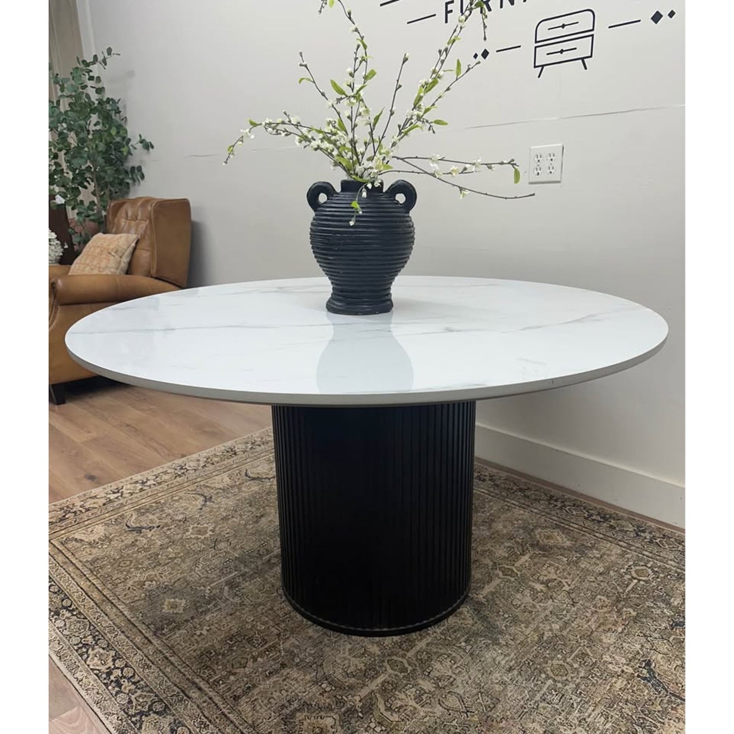 Colvin 54-Inch Round White Marble Table Black Ribbed Base By Steve Silver