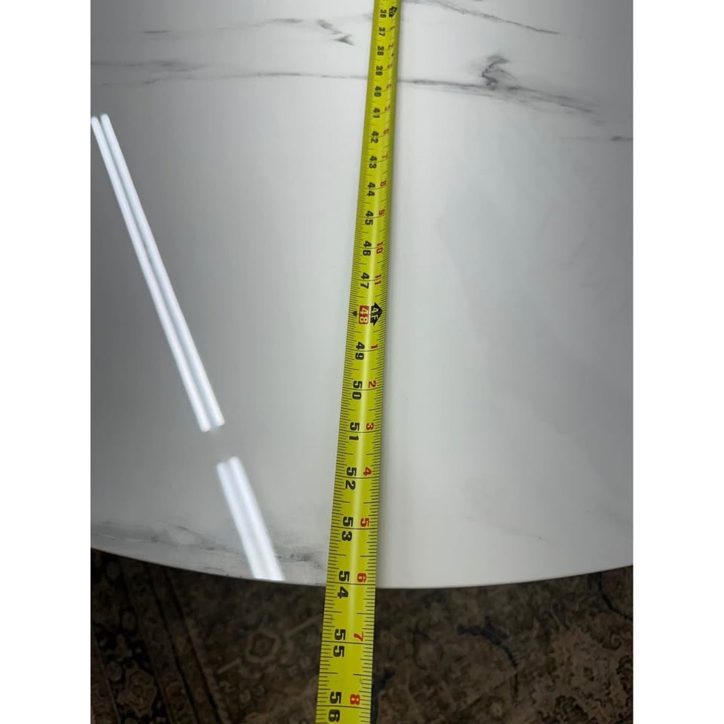 Colvin 54-Inch Round White Marble Table Black Ribbed Base By Steve Silver